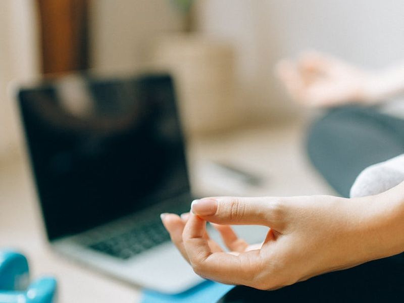 A clean and spacious room for home workouts with a yoga mat on the floor.